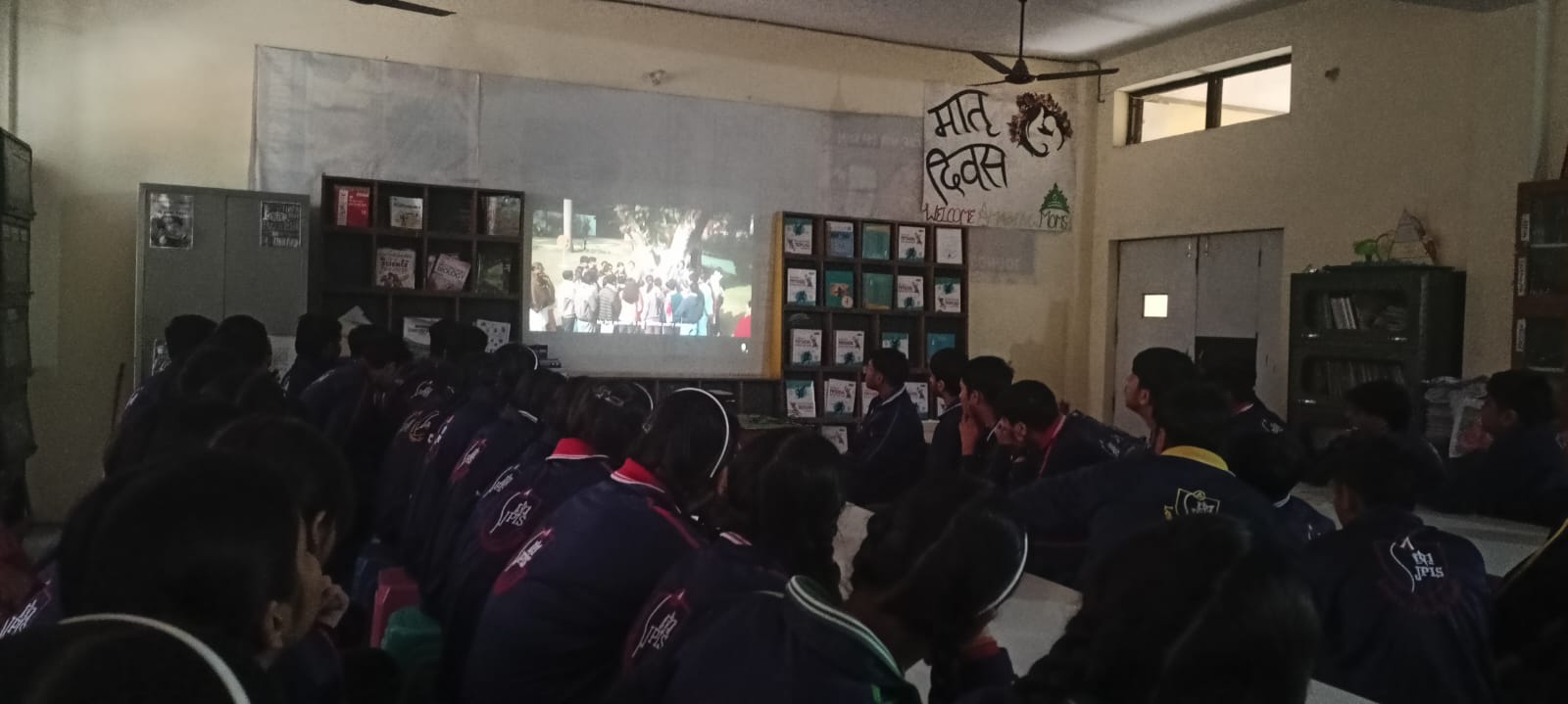 Students watching a presentation in the library